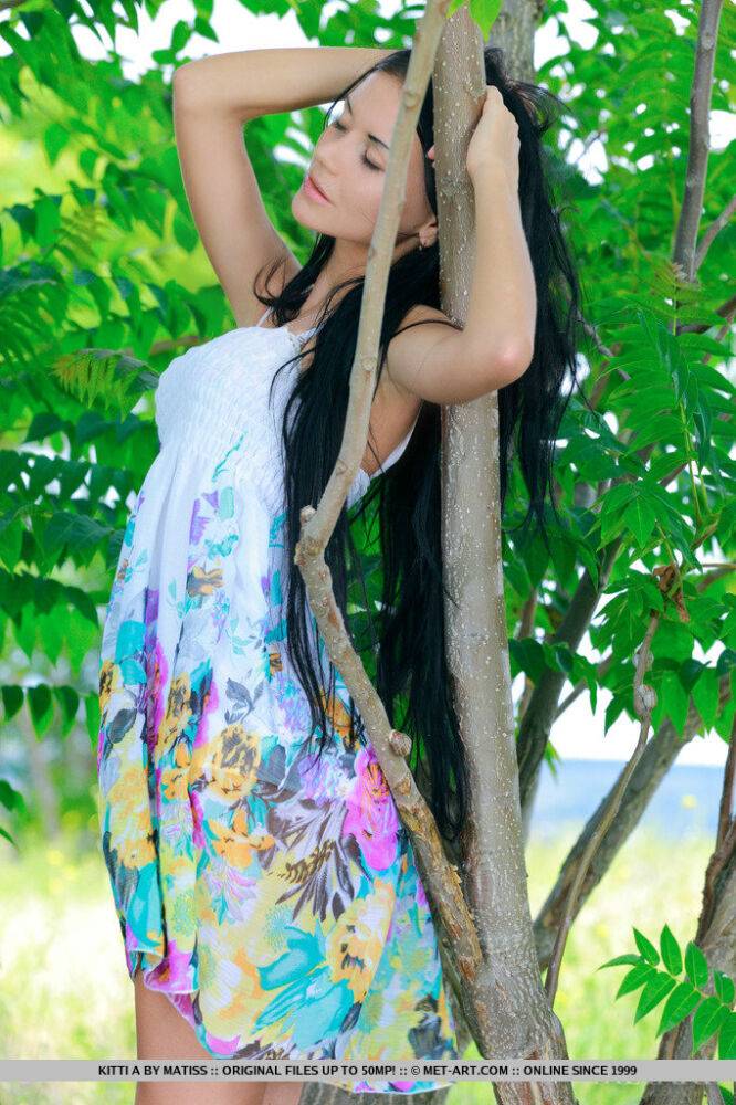 Dark haired Russian teen Kitti A strips totally naked under a tree - #7