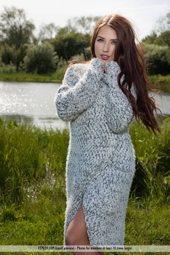 Beautiful female Niemira removes a knitted dress to pose nude in a field - #11