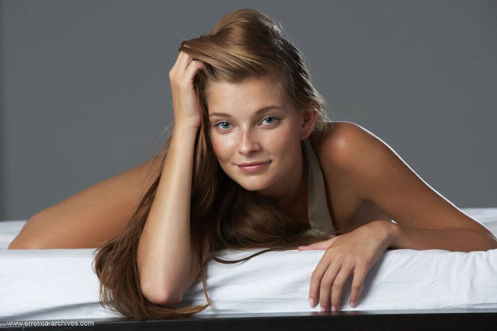 Young Russian girl with a nice smile poses her tan lined body in the nude - #1