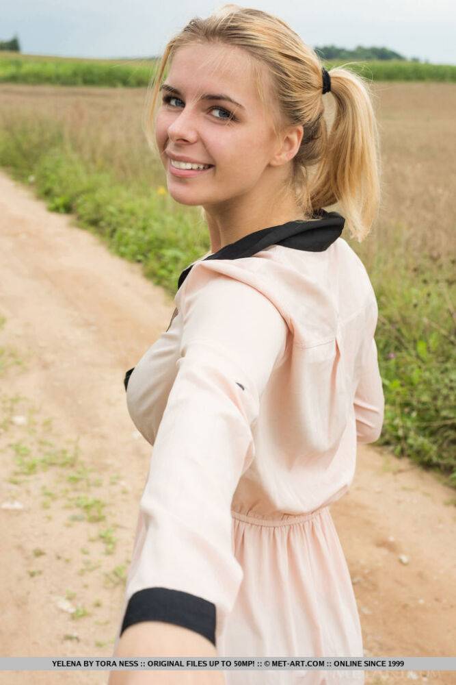 Young blonde Yelena gets totally naked in a farmer's field - #1