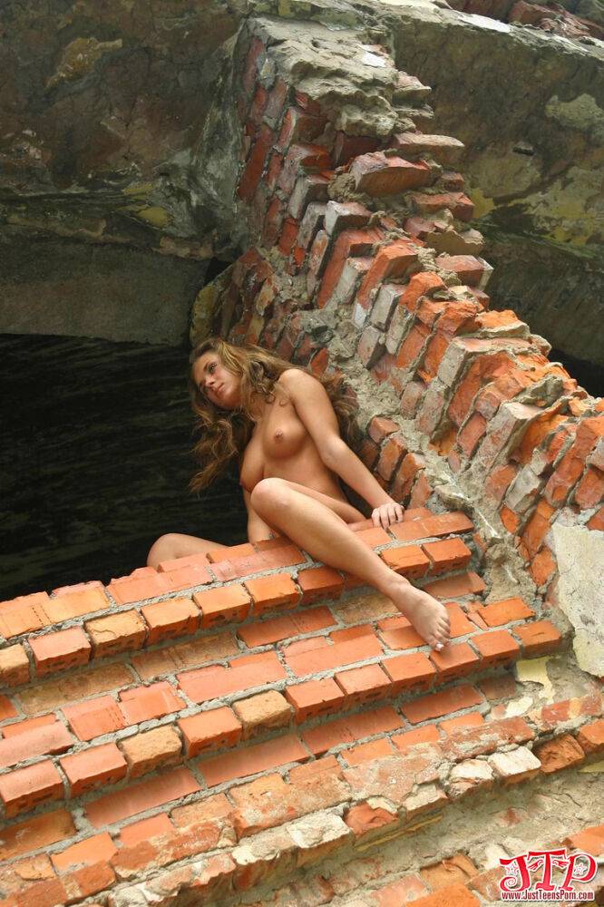 Naked teen strikes great solo poses amid ruins of a brick buidling - #1