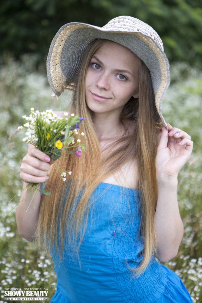 Petite teen Nastyshka doffs a sun hat and dress to pose nude in a field - #2