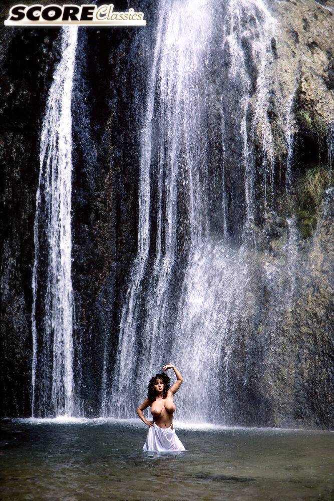 Solo girl Stacy Owen displays her huge breasts in front of a waterfall - #15