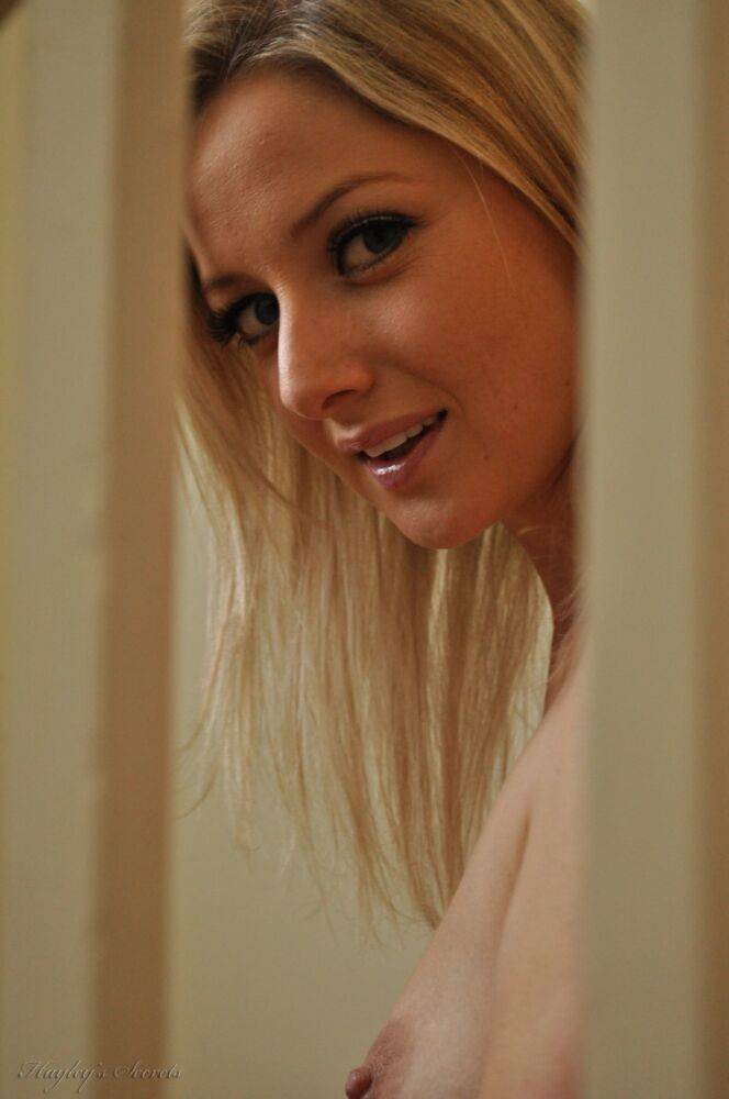 Blond amateur Nikki F slips off a dress to get naked by a window on stairs - #11