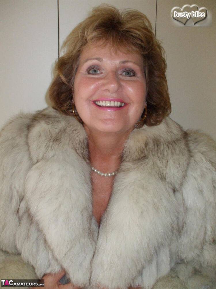 Chubby mature woman Busty Bliss releases her tan lined tits from a fur coat - #10