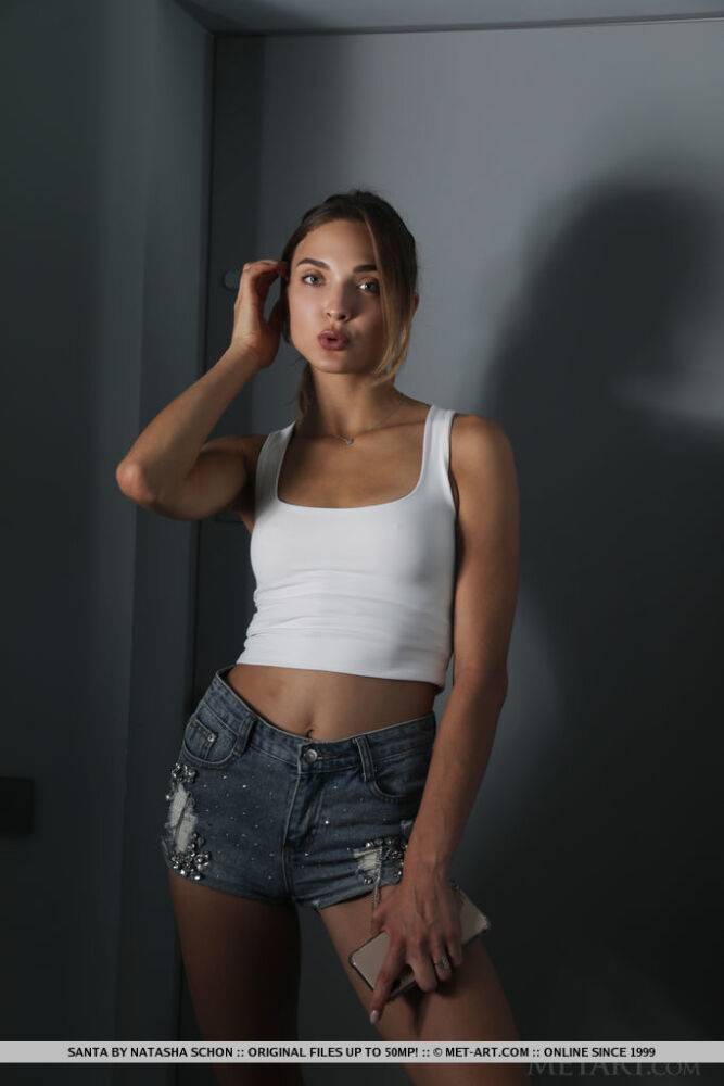 Beautiful teen Santa doffs a tank top and cutoff shorts to model in the nude - #13