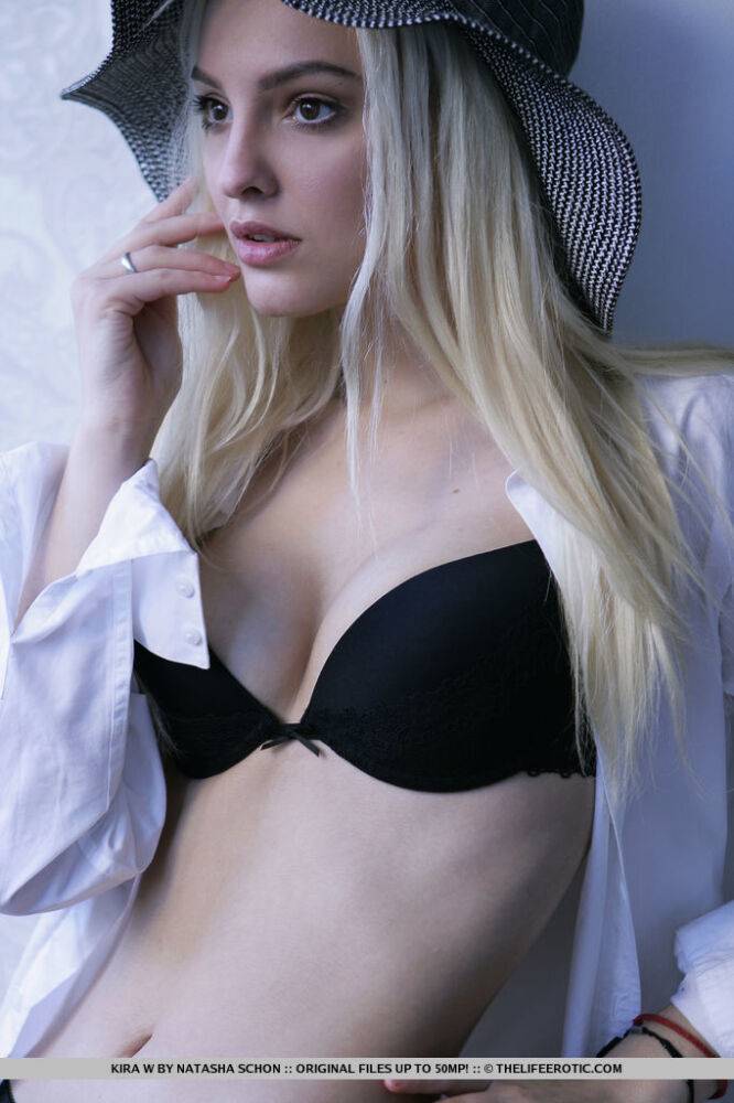 Blonde teen with a pretty face poses in black stockings in the soft sunlight - #7