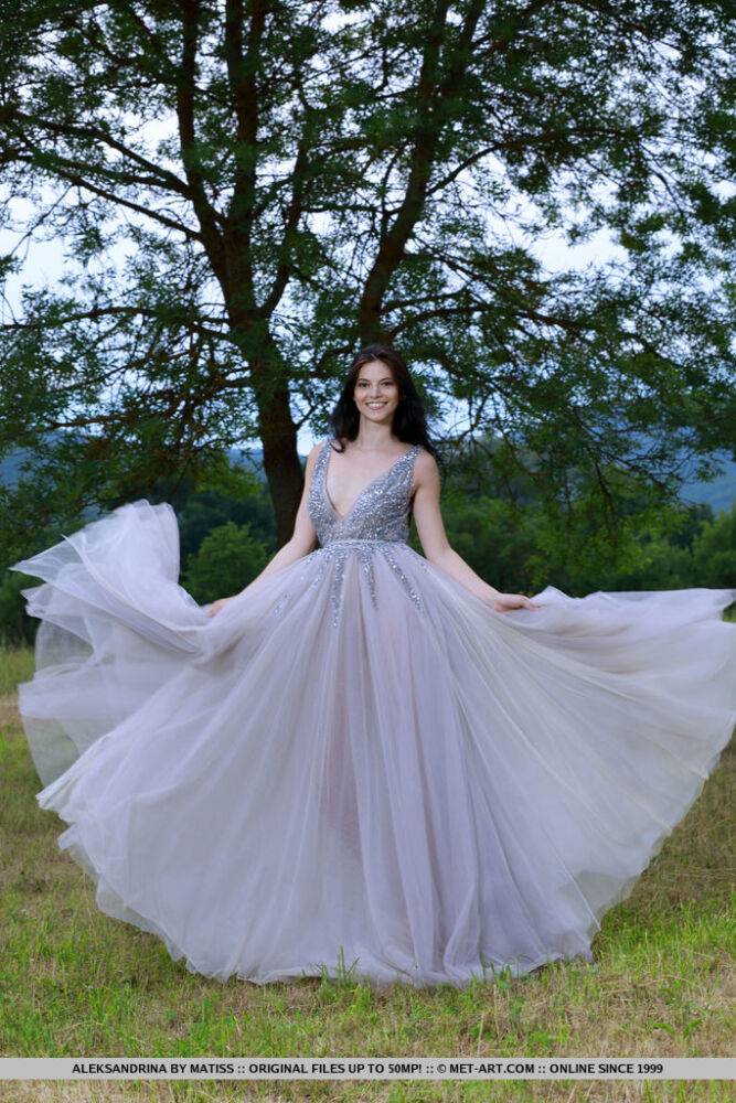 Dark haired teen Aleksandrina slips off a prom dress to pose naked in a field - #10