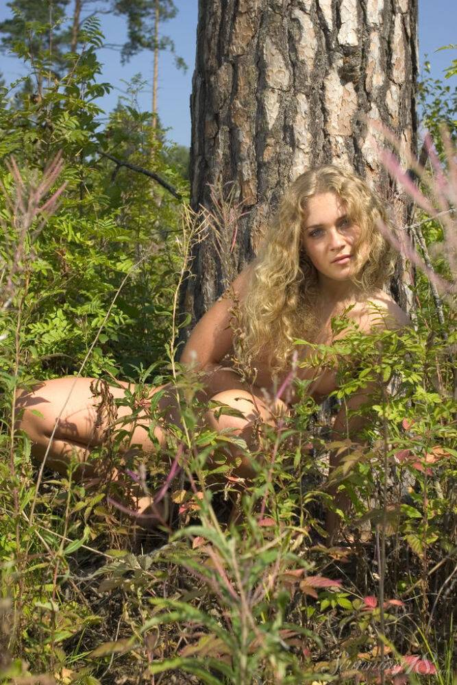 18-year-old with curly blonde hair poses totally nude on a tree stump - #5