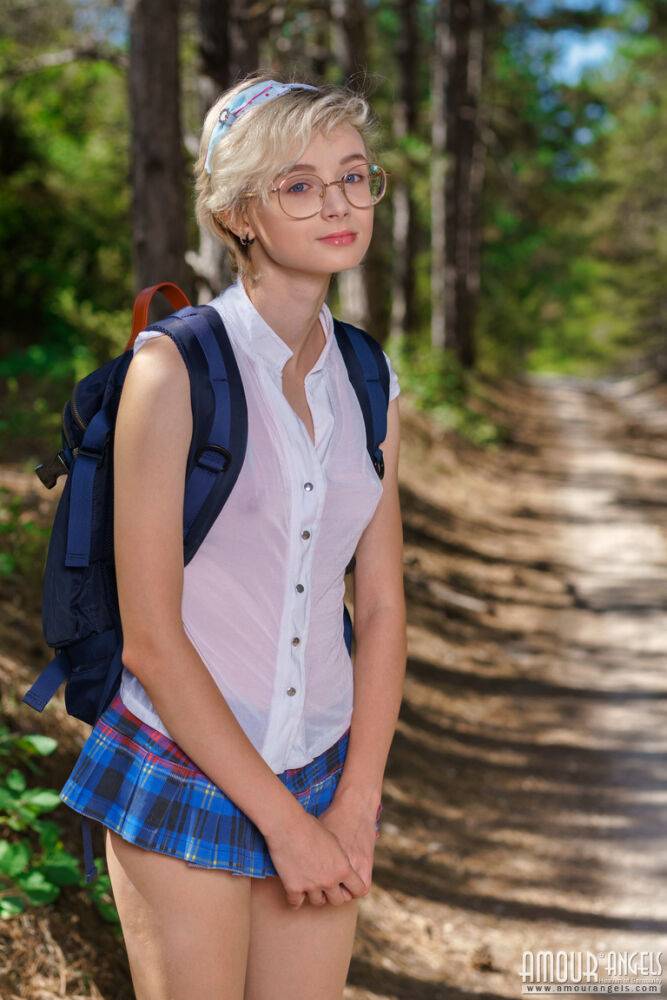 Young looking girl Azshara strips off school clothes on a dirt road in woods - #15