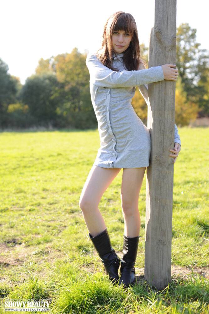 Teen exhibitionist Lena removes a coat before flashing on a soccer field - #8