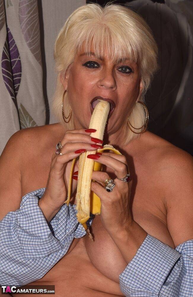 Mature blonde Dimonty peals and eats a banana with her shirt undone - #9