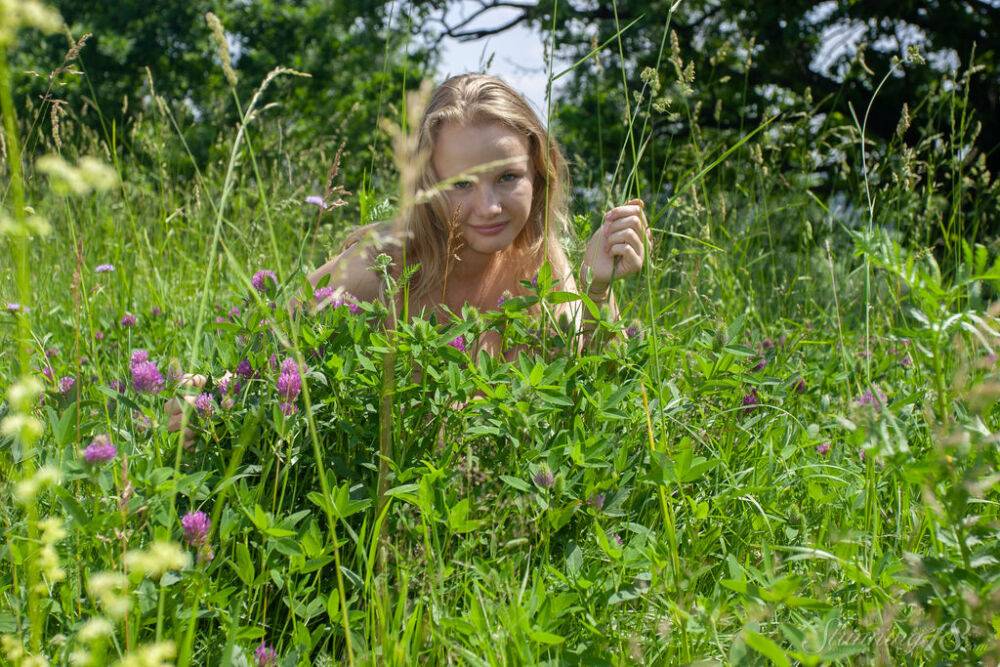 18 year old blonde Kate models totally naked while in a field - #16