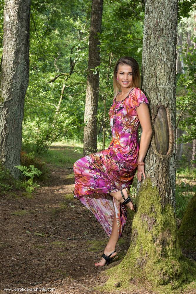 Teen model Zora A highlights her bald slit while naked in a forest - #9