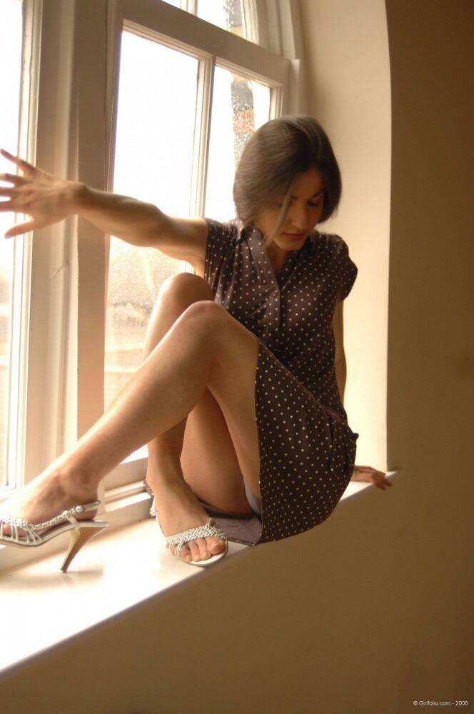 Solo girl slips off her dress and underthings in front of a window - #4