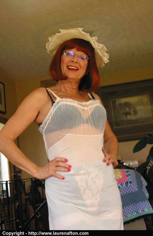 Older redhead Miss Abigail changes into a full length slip with glasses on - #9