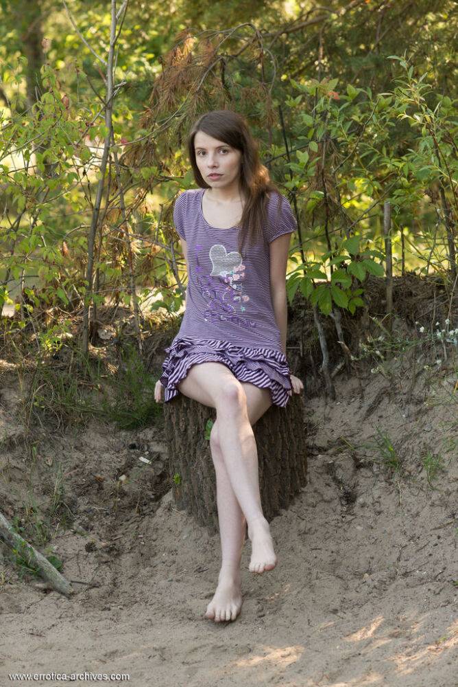 Young brunette Jemma A gets totally naked on a stump near some trees - #12