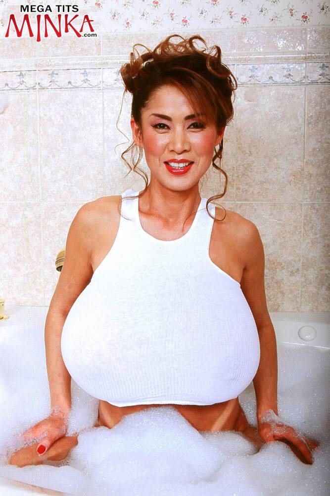 Older Asian lady Minka bares her trimmed pussy and giant tits in a bathtub - #12