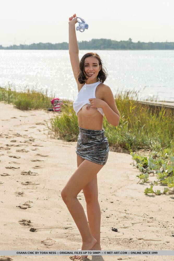 Teen solo girl Oxana Chic grabs her bare ass after disrobing at a public beach - #15