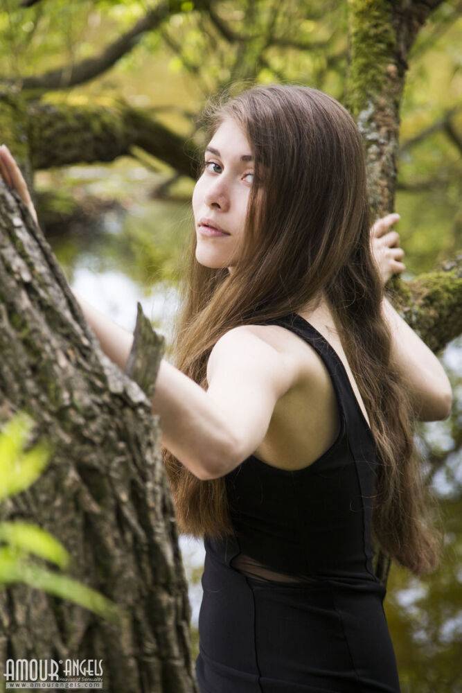 Barefoot teen Londa removes a black dress to pose nude in a tree - #13