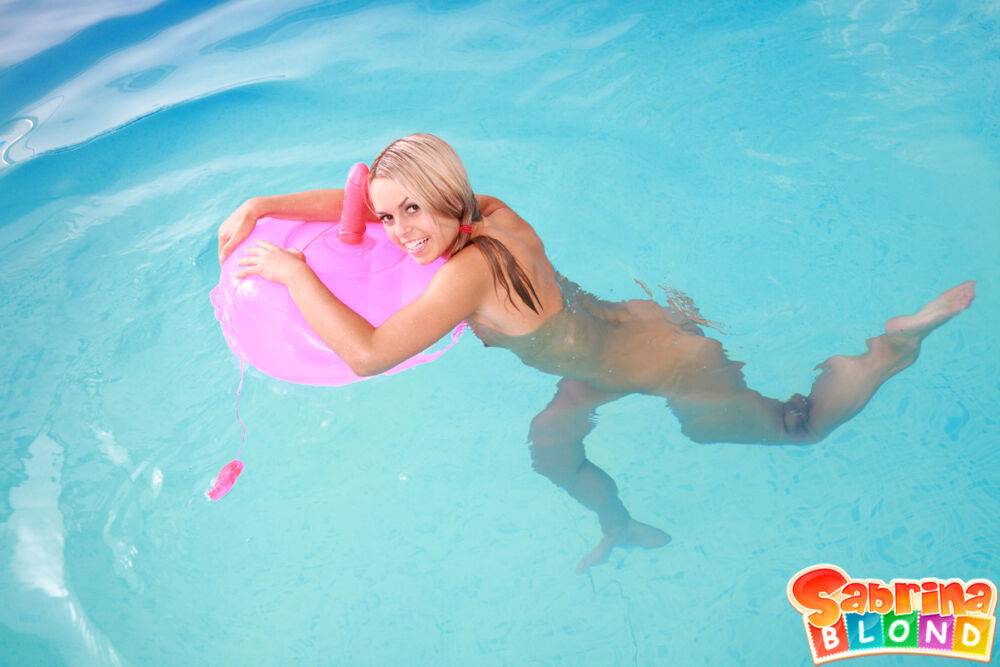 Adorable teen Sabrina Blond rides a dildo ball after a dip in an indoor pool - #7