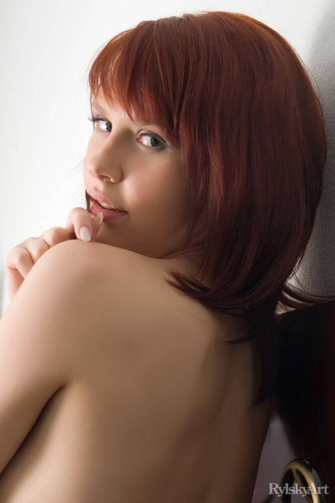 Pale redhead Anelie casts sultry looks while getting naked on a window sill - #14