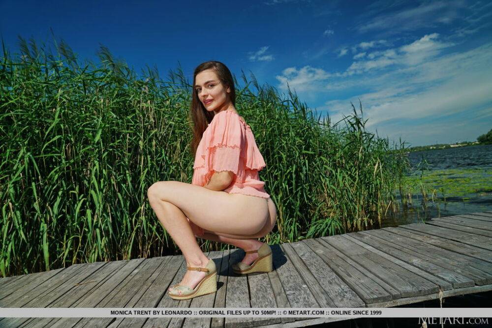Long haired teen Monica Trent strikes great nude poses on a dock | Photo: 2241922