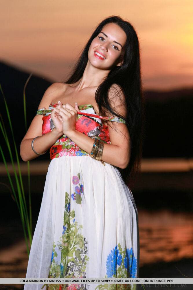 Dark-haired teen Lola Marron slips out of a long dress to pose nude at sunset - #14