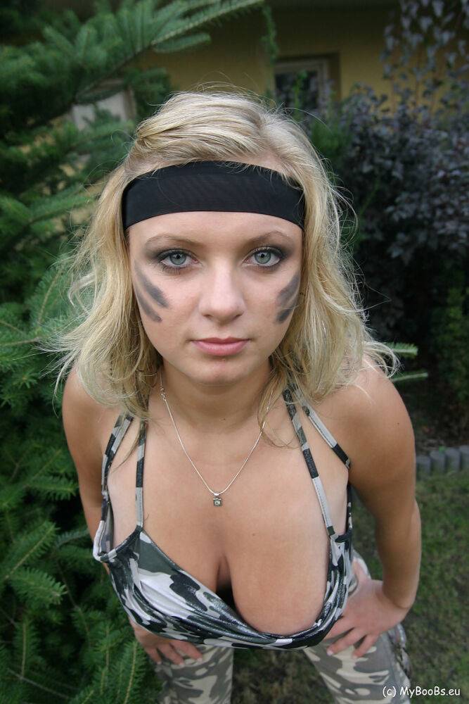 Blonde chick Malina May shows her nice tits in a backyard while in camouflage - #13
