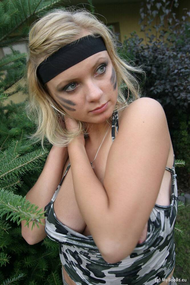 Blonde chick Malina May shows her nice tits in a backyard while in camouflage - #1