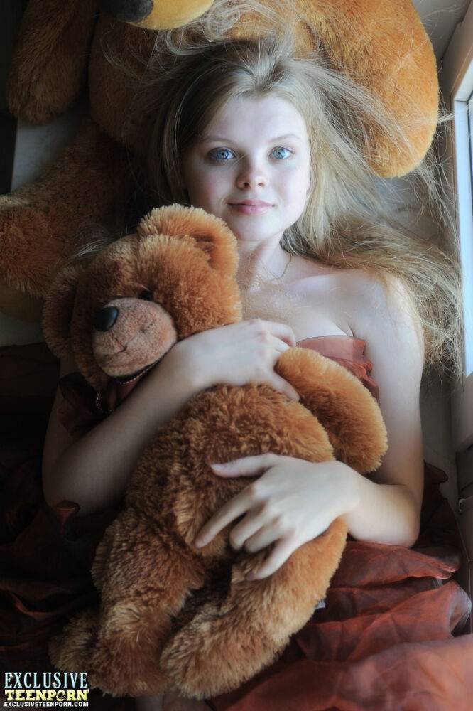 Tiny teen Kisa strikes tempting nude poses while holding a teddy bear - #9