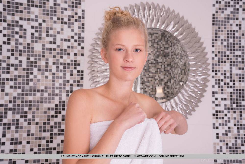 Young looking blonde Lauma removes a bath towel before getting in the bathtub - #8