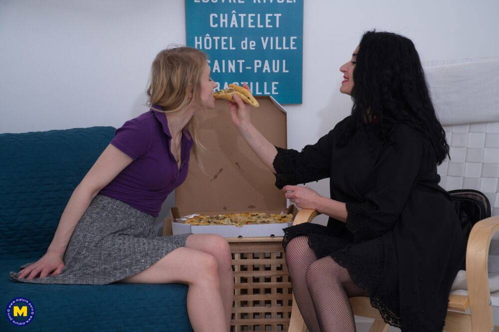 Older and younger lesbians share a pizza before 69 action on a bed - #11