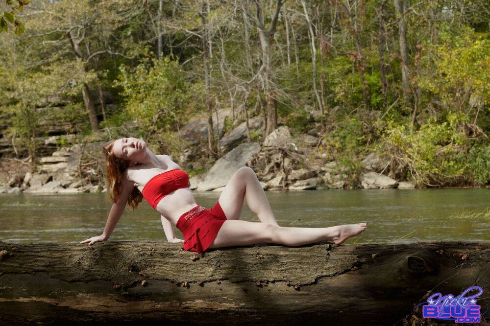 Young redhead Nicki Blue bare her small tits while standing in a stream - #13