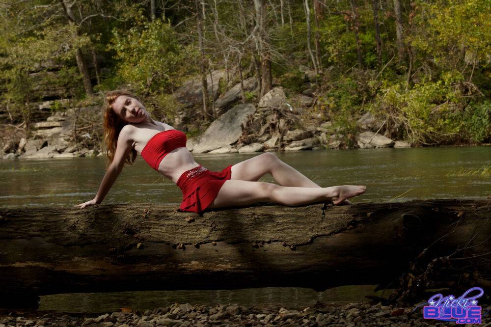 Young redhead Nicki Blue bare her small tits while standing in a stream - #12