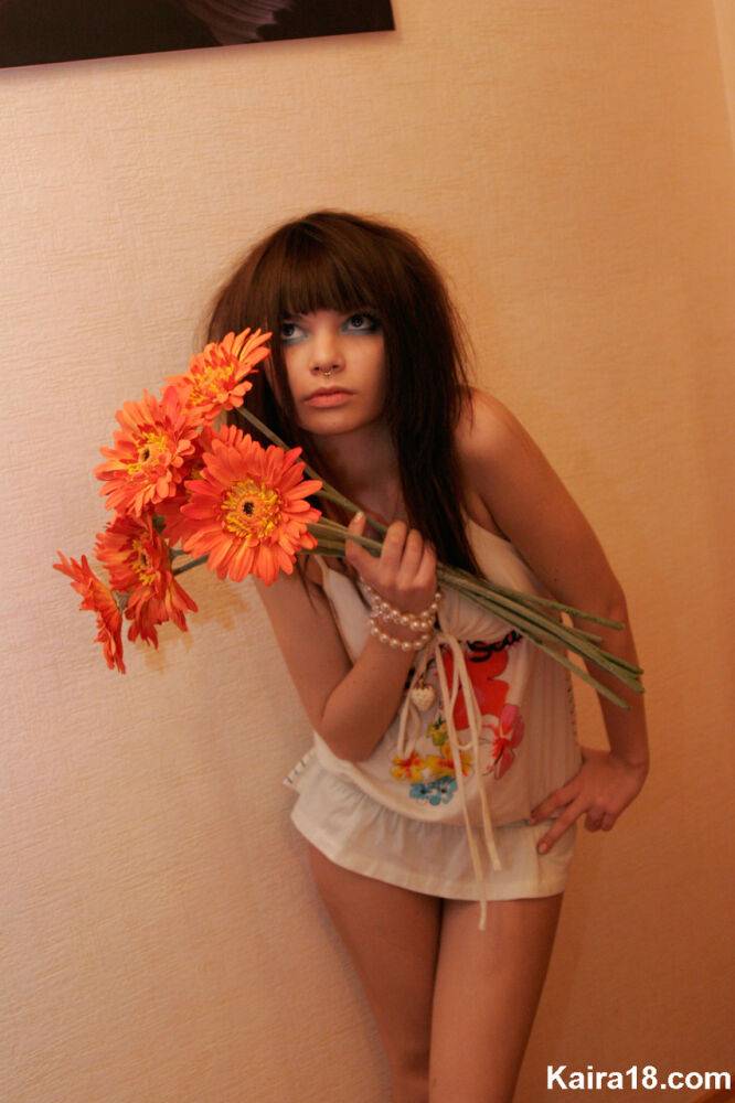 Charming teen Kaira 18 holds a bunch of flowers during a non nude shoot - #9