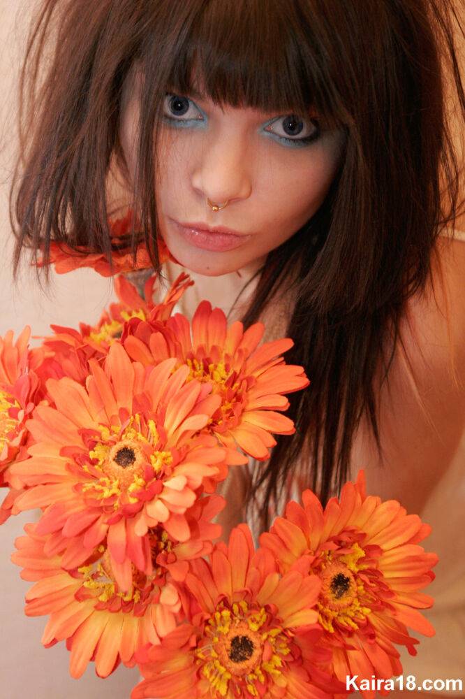 Charming teen Kaira 18 holds a bunch of flowers during a non nude shoot - #1