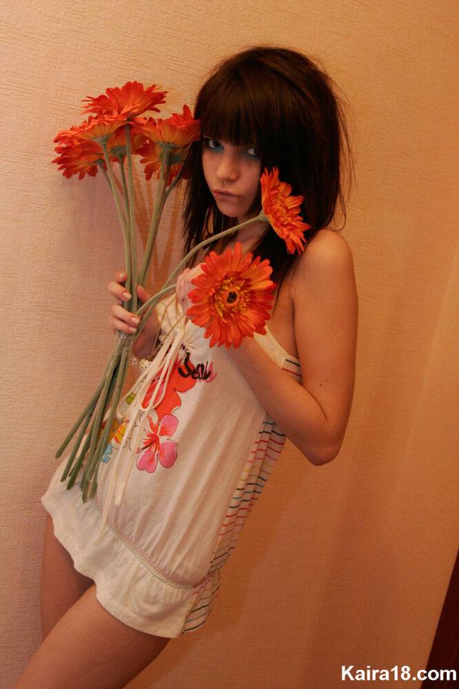 Charming teen Kaira 18 holds a bunch of flowers during a non nude shoot - #8