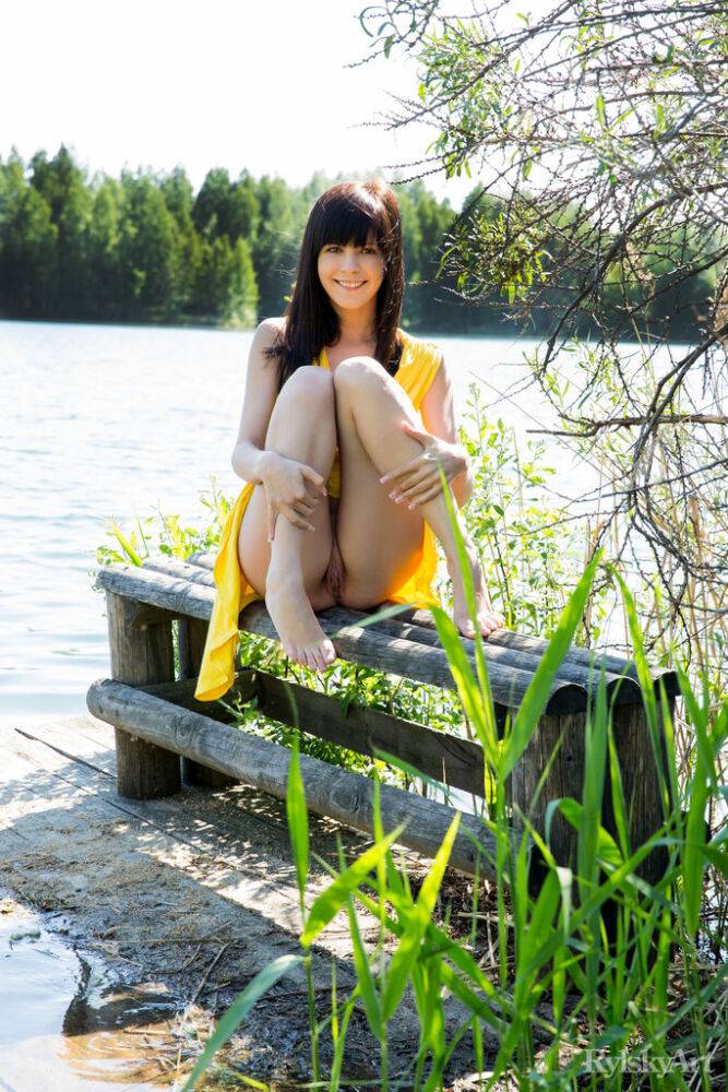 Young brunette girl in a yellow dress flashes her girl parts by a river - #16