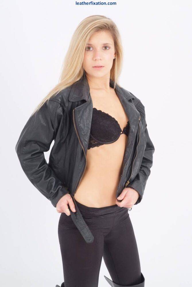 Blond chick unzips her leather jacket in a black bra and leggings - #9