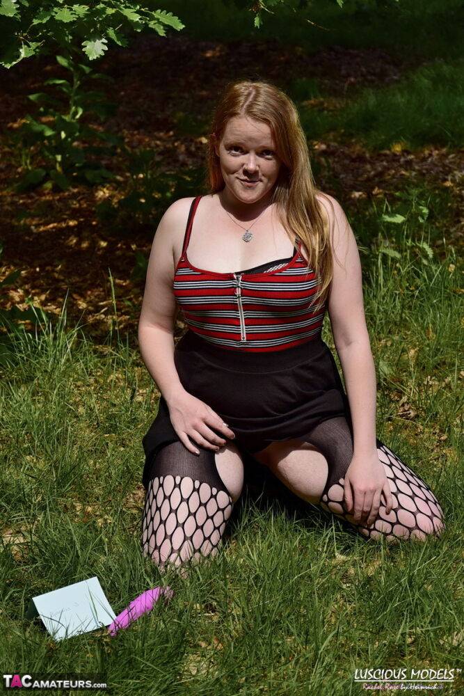 Redheaded amateur exposes her tits during upskirt action in a field - #16