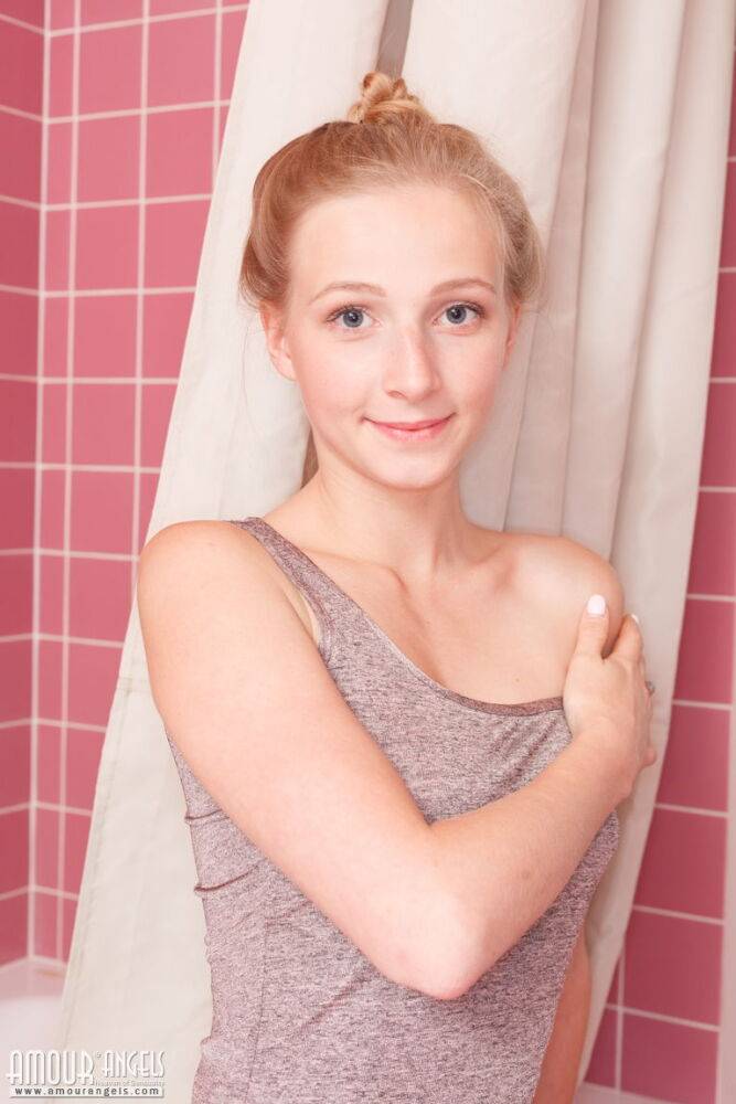 Fair skinned teen wears her hair up while getting wet during a shower - #6