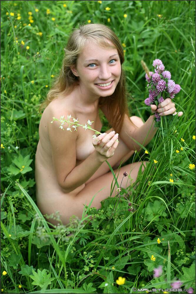 Blonde chick wears nothing but a smile while holding flowers in a meadow - #6