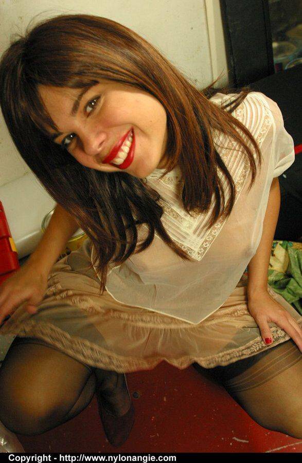 Amateur girl with red lips strips to a garter belt and nylons in a workshop - #6