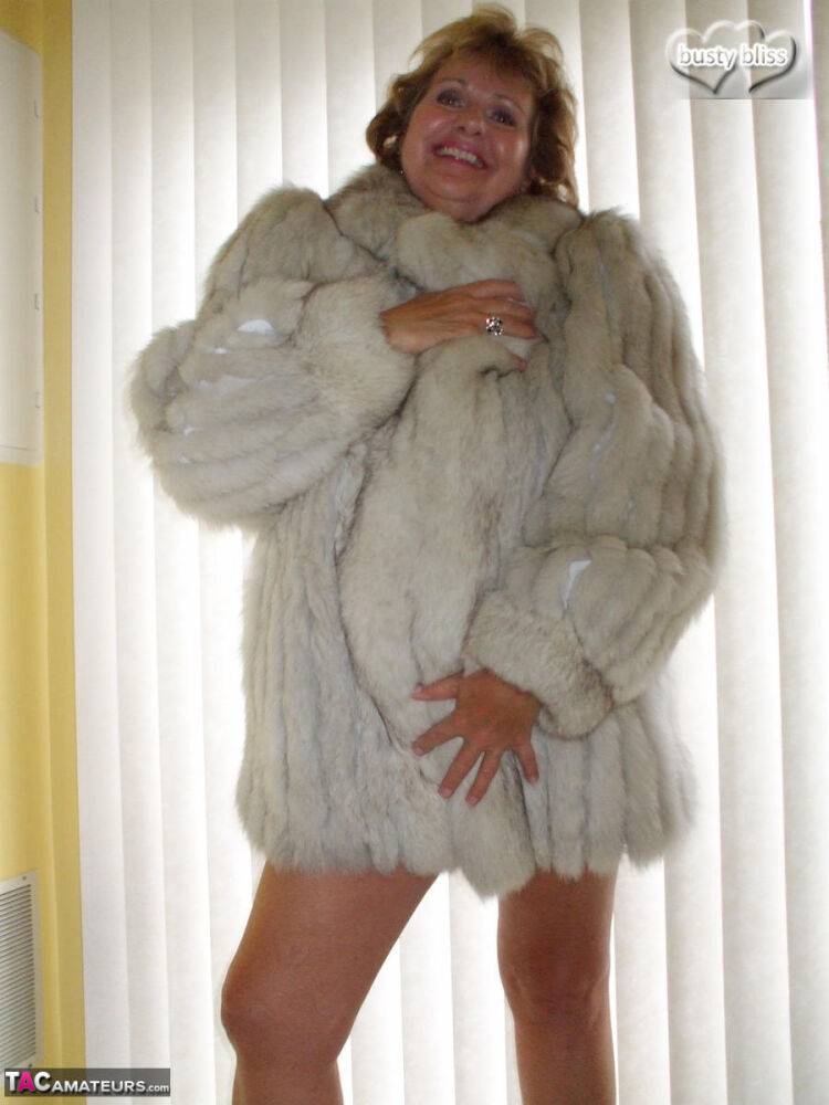 Mature amateur Busty Bliss exposes her tan lined tits while wearing a fur coat - #11