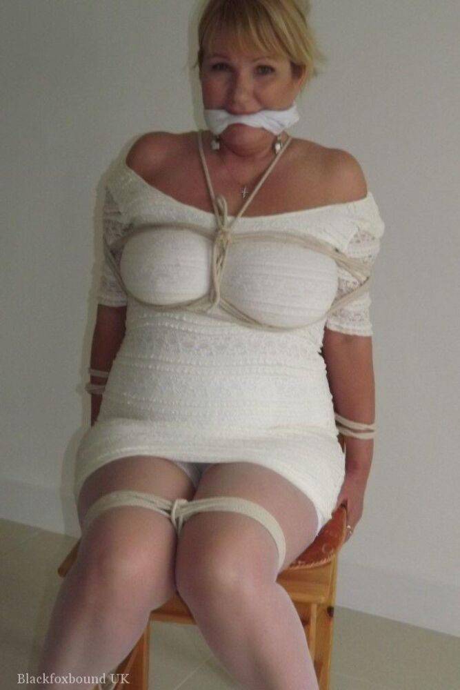 Blonde female is cleaved gagged and tied with rope in a number of dresses - #15