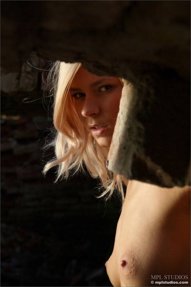 Blonde model strikes confident nude poses beneath a brick overpass - #12