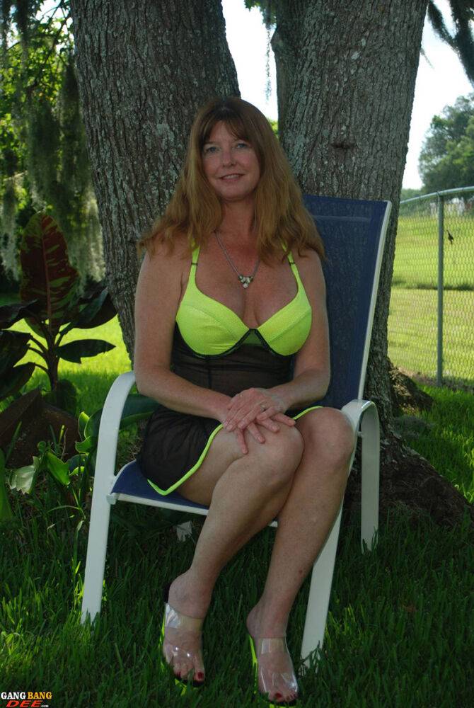 Mature amateur Dee Delmar teases in see thru lingerie underneath a shade tree - #14