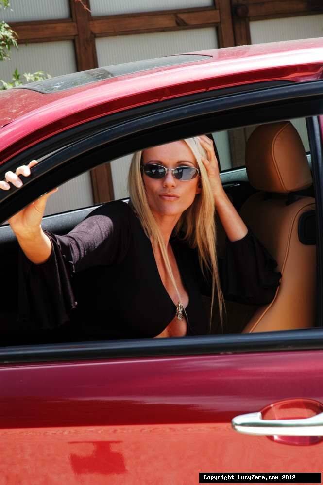Hot blonde chick Lucy Zara flashes a no oanty upskirt in a sports car - #4