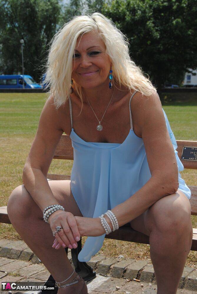 Hot mature Platinum Blonde flashes a hot panty upskirt on a park bench - #10